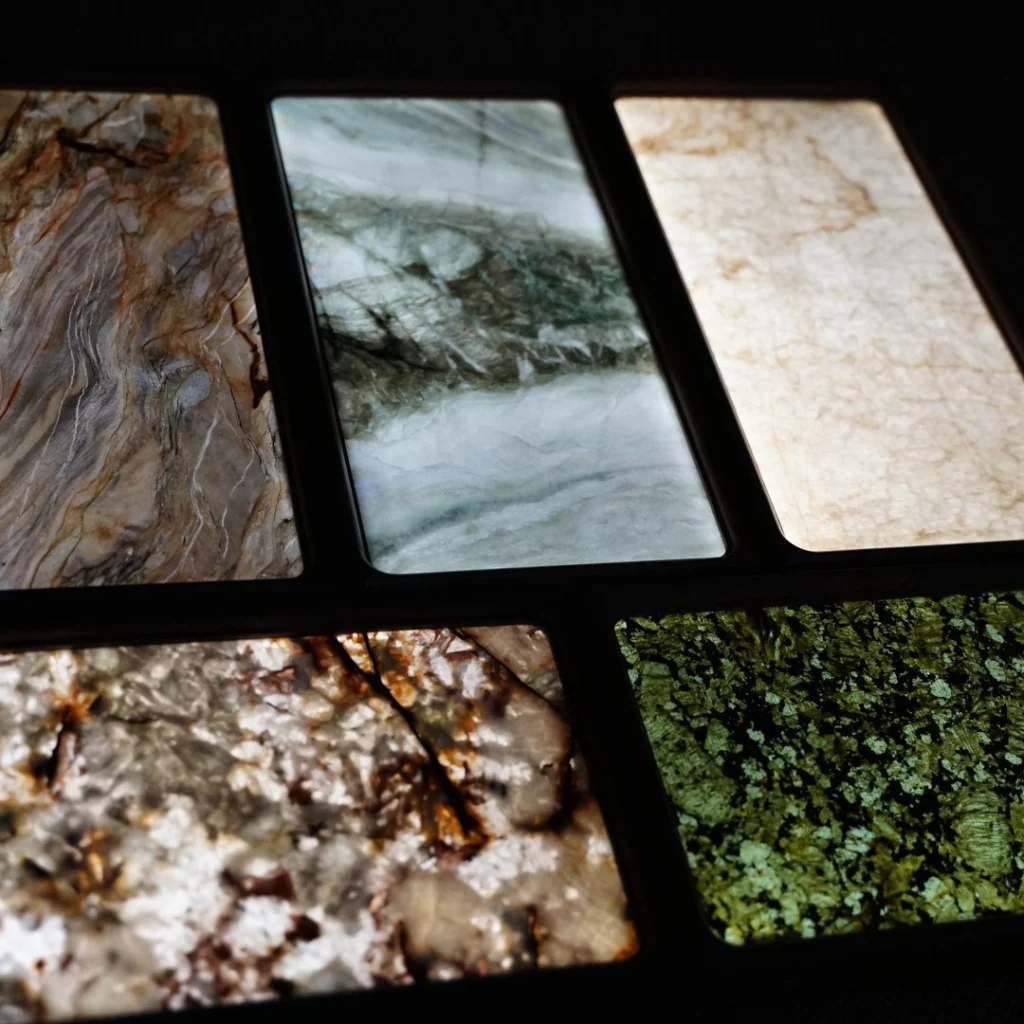 Lit stone panels in green, white and amber