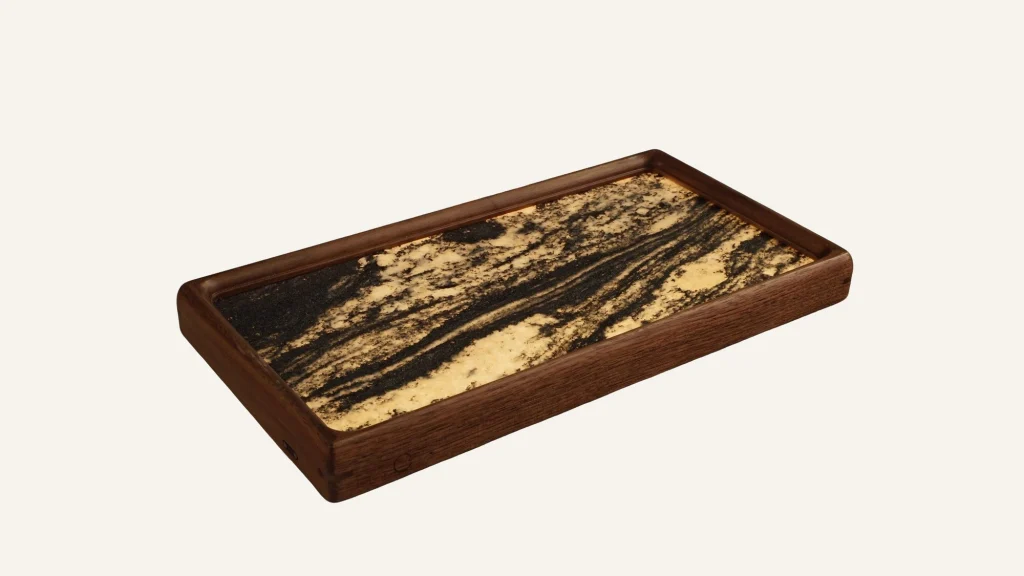A walnut tray with a gold-veined black stone surface